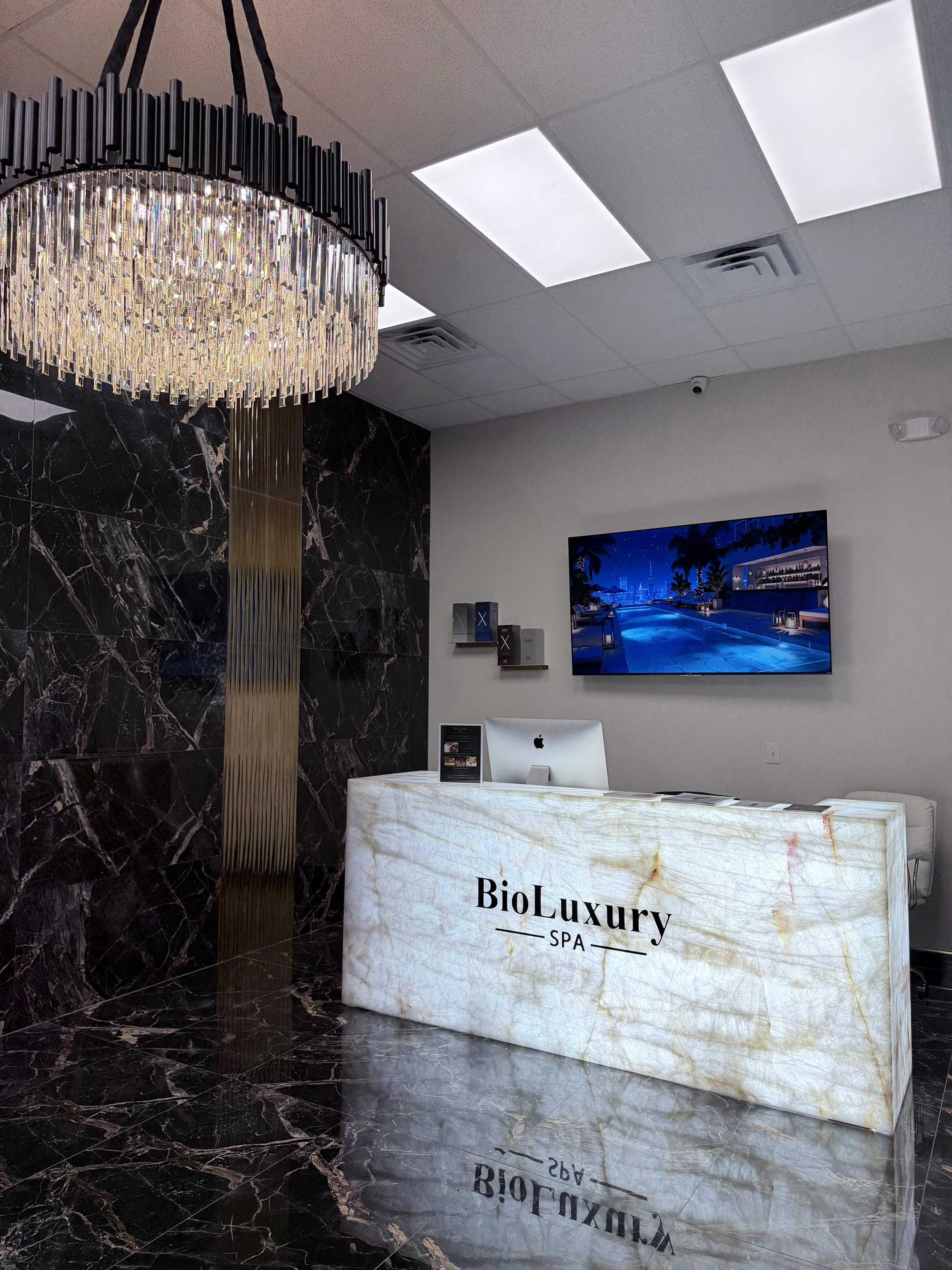 Elegant marble reception desk with chandelier