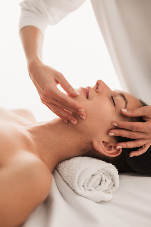 Woman receiving relaxing facial massage